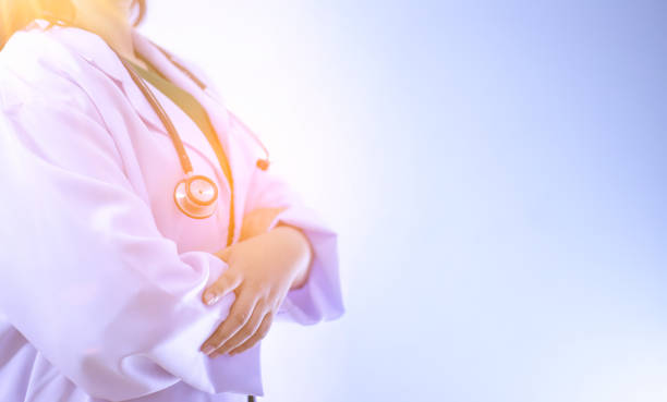 istock Midsection Of Doctor Standing Against Blue Background 1093116986