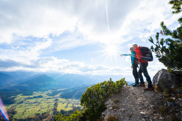 istock hiking couple viewing mountain range and valley 1093117104