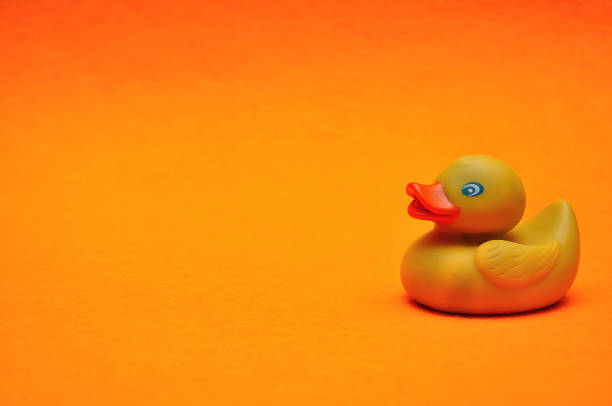 istock A rubber duck on an orange background 1093123954