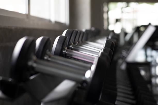 istock Dumbbells on rack, with different weight, macro shoot and very detailed on lifting handle, Standard equipment in all gym. 1093125642