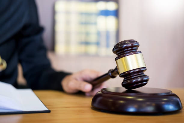 istock Close-Up Of Judge Holding Gavel On Table 1093127554