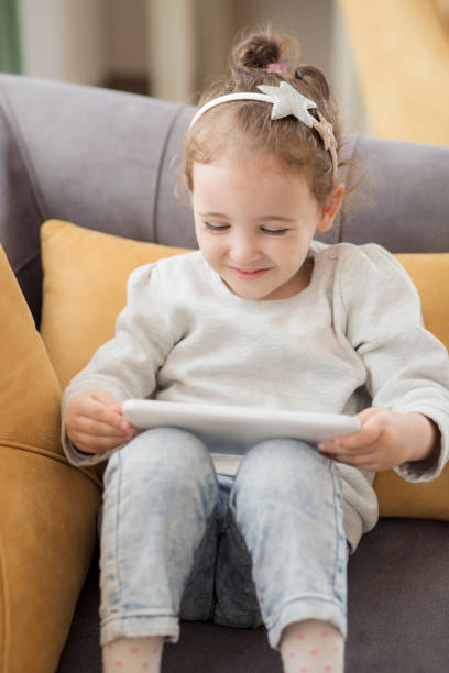 istock Cute little girl using a digital tablet 1093148632