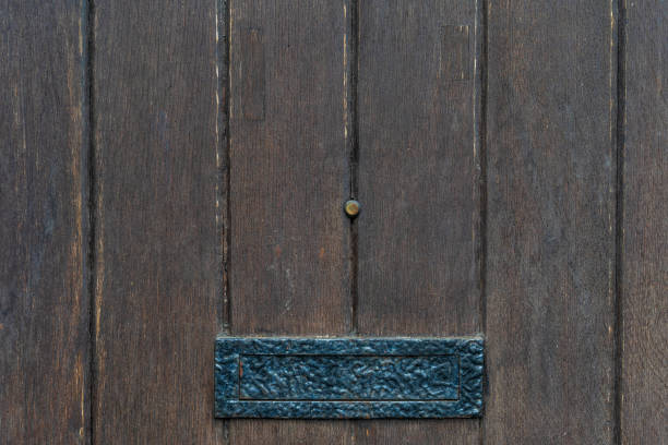 istock Vintage black door panels with ancient letterbox - high quality texture / background 1093157018