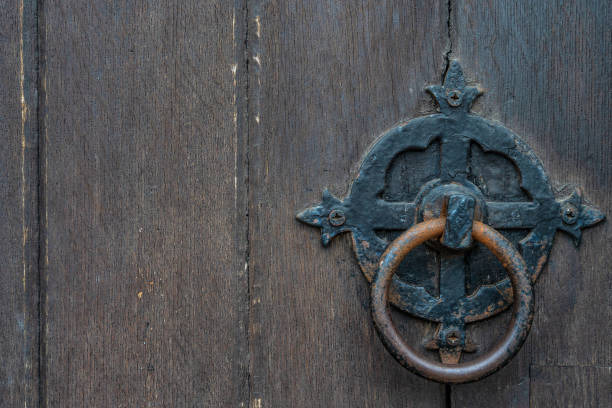 istock Vintage black door panels with ancient knocker - high quality texture / background 1093157208
