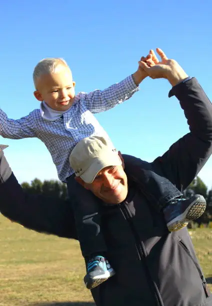 Photo of fatherand and his little son having fun on the beach