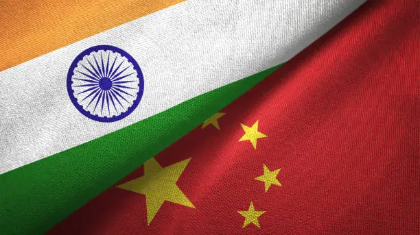 Photo of China and India two flags together textile cloth fabric texture