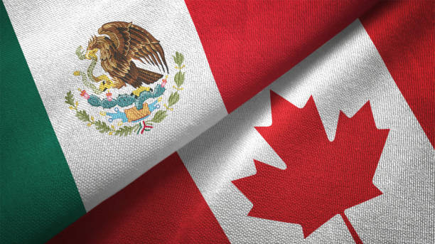 istock Canada and Mexico two flags together textile cloth fabric texture 1093175524