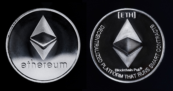 Silver cryptocurrency coin isolated on black background. Moscow, Russia - November 26, 2018