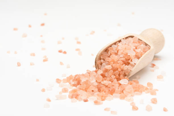 istock Wooden scoop with Himalayan salt on white background 1093180242