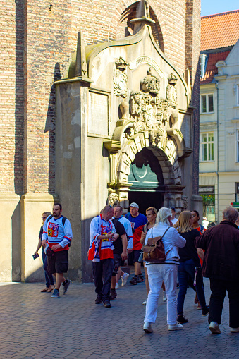 City Hall Square, Copenhagen with the entrance to the round tower (Rundetaarn) built by Christian IV in the 17th century near Copenhagen's City Hall, it is used as an observation tower and astronomical observatory. There are tourists and ice hockey supporters walking past the entrance.