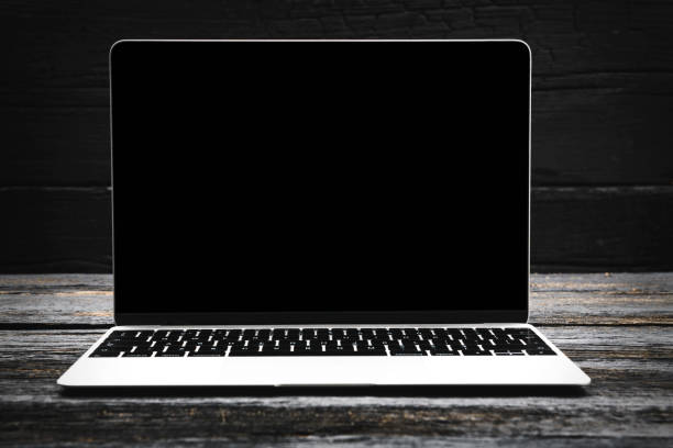 laptop computer on black wooden background with copy space