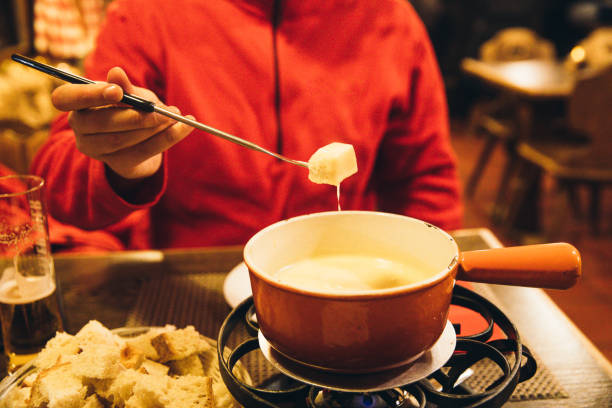 istock Man eats fondue over Christmas in Switzerland 1093192526