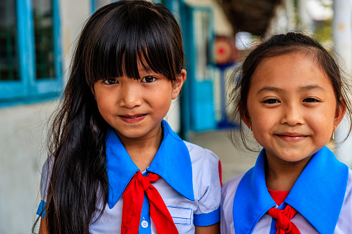 Happy Vietnamese schoolgirls on a schoolyard, South Vietnam