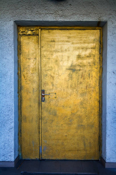 istock Painted in gold door with a blue white wall 1093197470