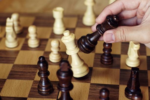 istock Chess board game, queen takes queen protecting king, encounter difficult situation, business competitive concept, copy space 1093200096