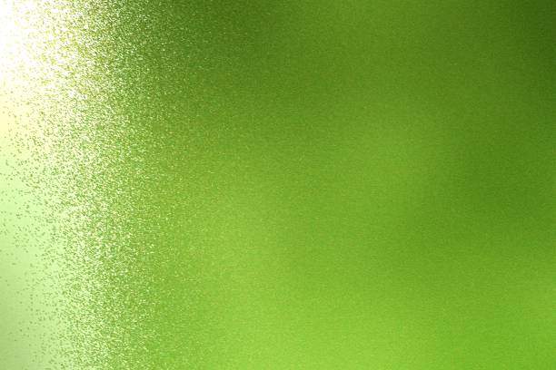 Light shining on rough green metal wall texture, abstract background