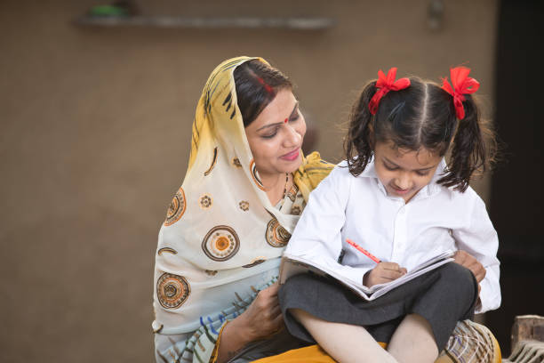 istock Rural mother helping daughter with her homework 1093206240
