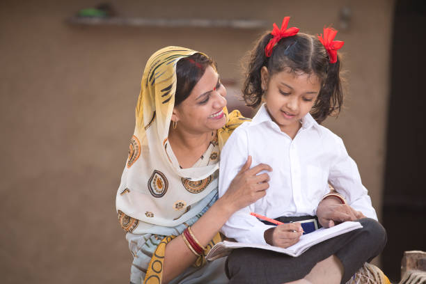 istock Rural mother helping daughter with her homework 1093206284