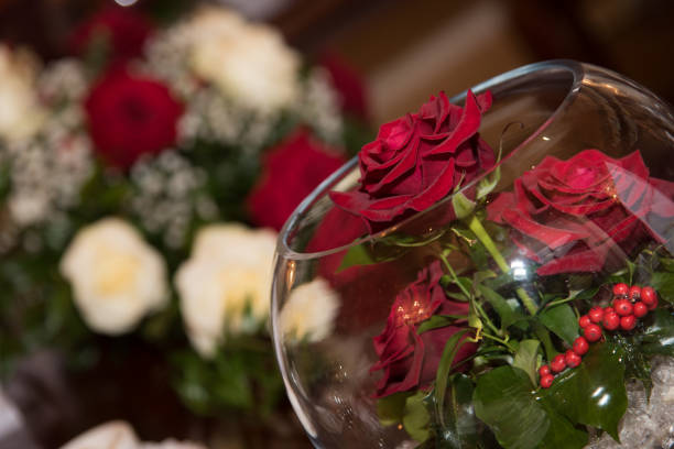 Yellow roses in silver vase on linen table top