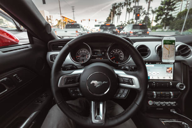 Los Angeles, California, USA - March 22, 2016: Interior view of a Ford Mustang car dashboard during the day stuck on the traffic. The Mustang is an iconic american couple made by Ford in USA.