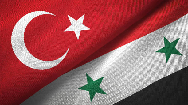 siria e turchia due bandiere insieme tessuto tessuto tessuto texture - turchia foto e immagini stock
