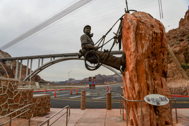 Hoover Dam Heroes Boulder City, Nevada, USA - January 05, 2019: "Heroes Of Hoover" The building of Hoover was a ray of hope for a nation struggling with hard times. Newsreel images of the high-scalers who worked the canyon walls ignited public interest in the project hoover dam statues stock pictures, royalty-free photos & images