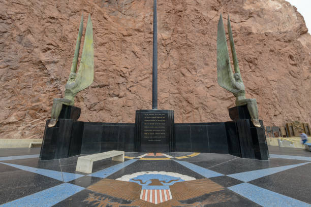 Hoover Dam flag sculptures Boulder City, Nevada, USA - January 05, 2019: Two of the famous sculptures of the Winged Figures of the Republic. Created by Oscar J.W. Hansen for the Hoover Dam in Nevada hoover dam statues stock pictures, royalty-free photos & images