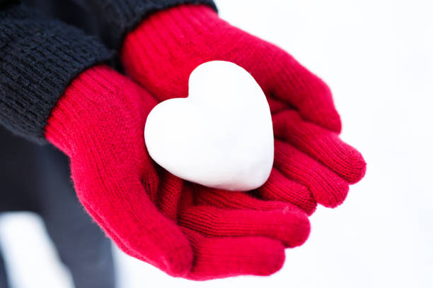 istock Woman hands holding snow heart 1093213818