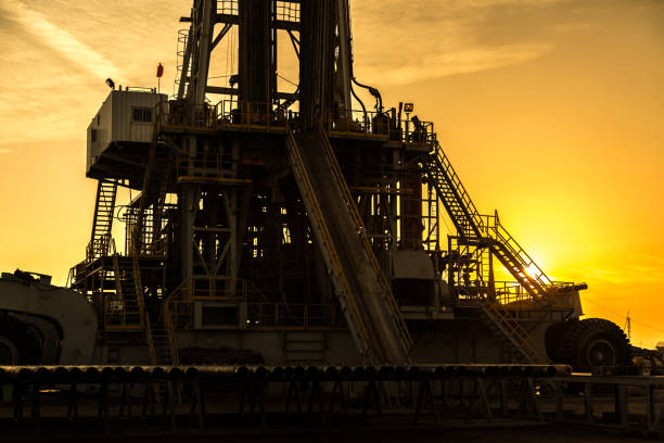 istock Oil drilling rig at sunset 1093216946