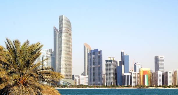 istock Abu Dhabi Skyline with water and palmtree 1093217096