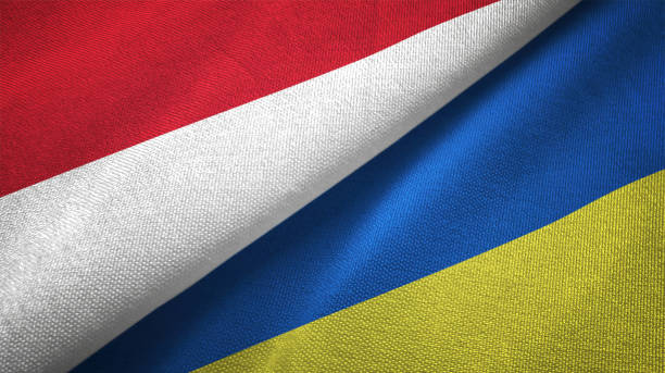 istock Ukraine and Indonesia two flags together textile cloth fabric texture 1093217100