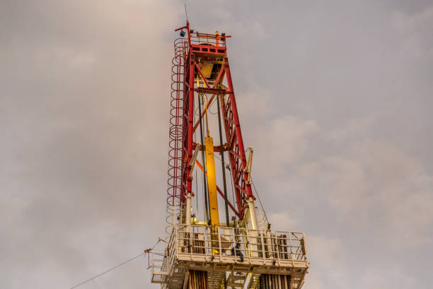 istock Oil drilling rig at sunset 1093220074