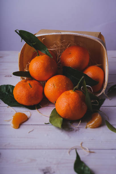 istock Fresh tangerines on a wooden background 1093222698