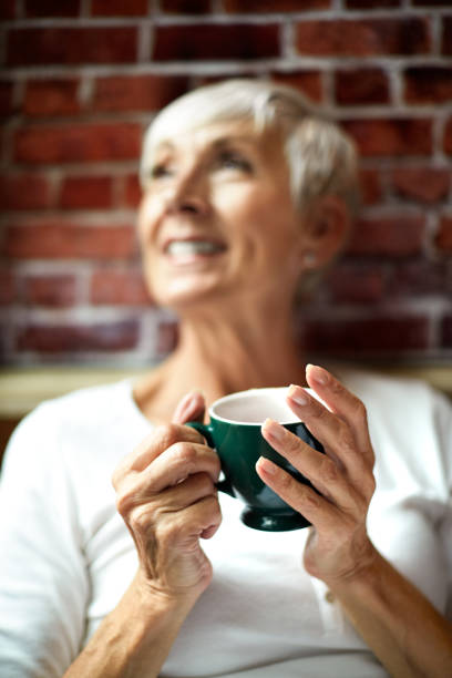 istock Lovely elderly woman feeling happiness while holding a cup of tea 1093224250