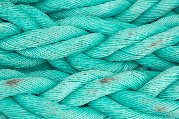 Nautical background. Old blue frayed ship rope closeup. stock photo