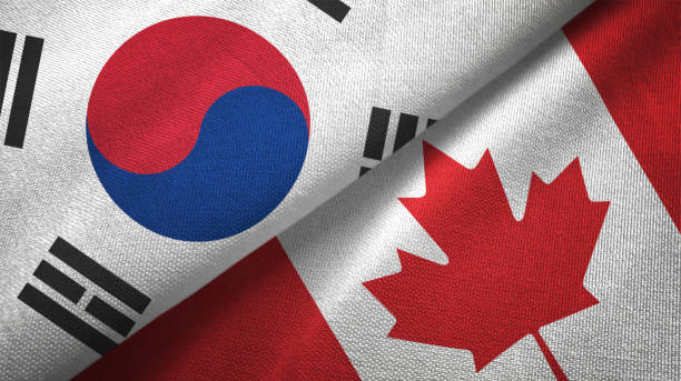 istock Canada and South Korea two flags together textile cloth fabric texture 1093227944