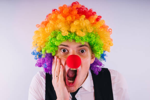 istock Office worker in clown wig, clown concept at work. 1093228178