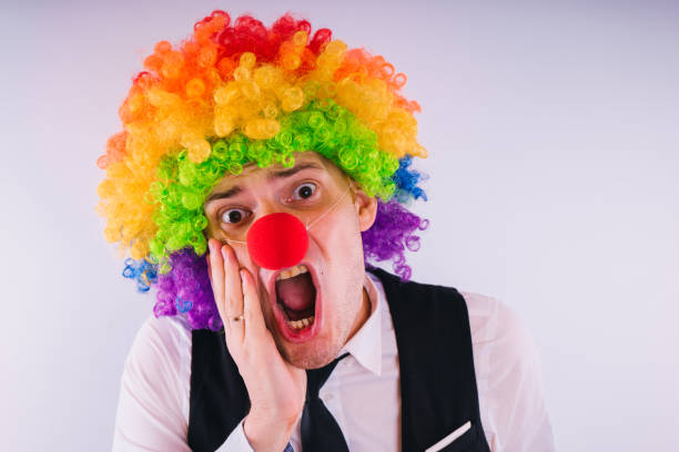 istock Office worker in clown wig, clown concept at work. 1093228192