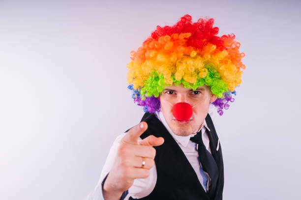 istock Office worker in clown wig, clown concept at work. 1093229336