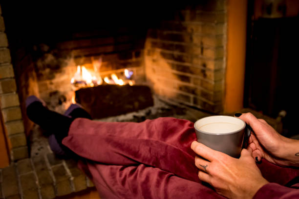 istock woman is warming in a fireplace 1093229808