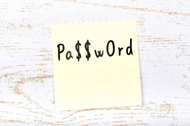 Yellow sticky note on wooden desk with handwritten message stock photo