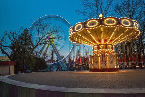 Children's Carousel at an amusement park in the evening and night illumination