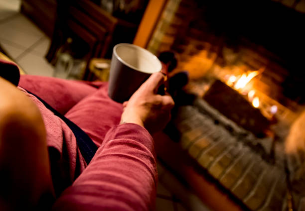 istock woman is warming in a fireplace 1093238414