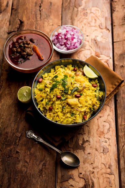 istock Aloo/Kanda Poha or Tarri Pohe with spicy chana masala/curry. selective focus 1093241938