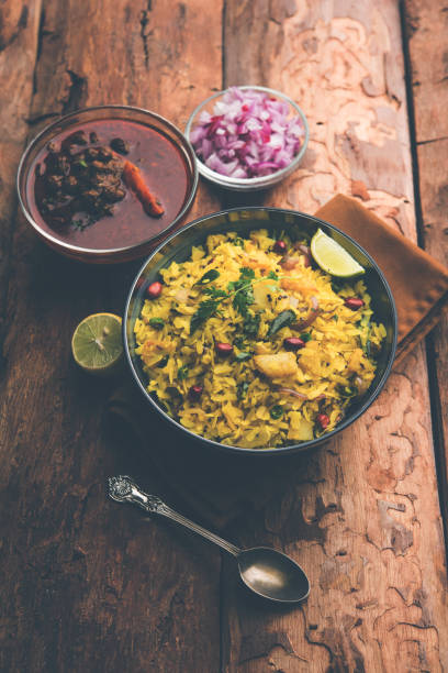 istock Aloo/Kanda Poha or Tarri Pohe with spicy chana masala/curry. selective focus 1093242032