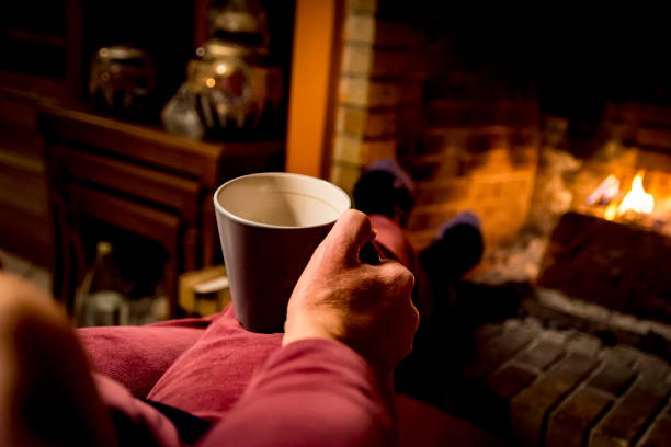 istock woman is warming in a fireplace 1093242404