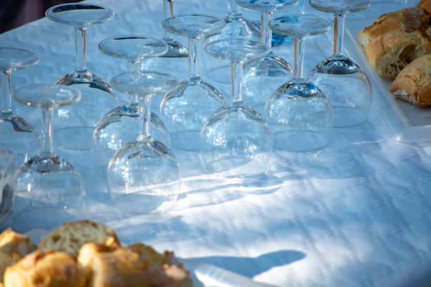 Table served outside in garden with many empty wine glasses for party or celebration or wine tasting