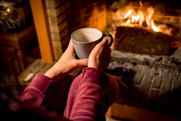 istock woman is warming in a fireplace 1093245668