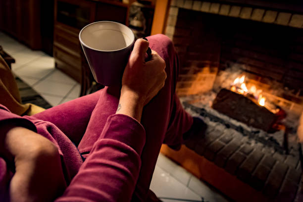 istock woman is warming in a fireplace 1093246724