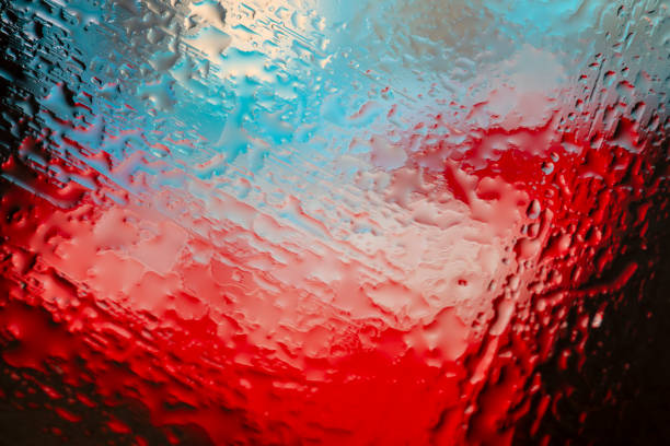 This macro and abstract photo is created by placing color objects outside the focus of the camera lens.The water or oil is on a glass material.